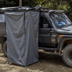 Fold out outlet shower tent